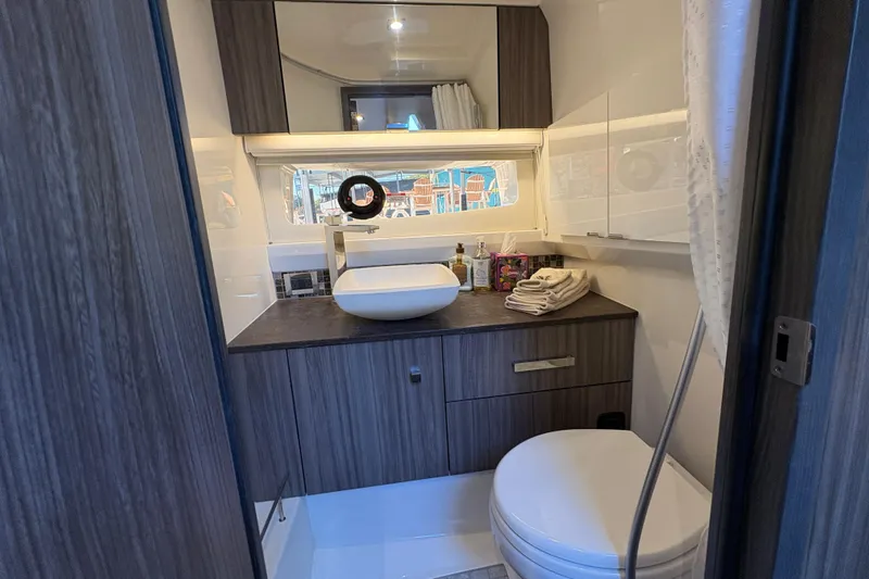  Yacht Photos Pics Luxurious bathroom in 2023 Sea Ray SLX 400 yacht with modern fixtures and elegant design.