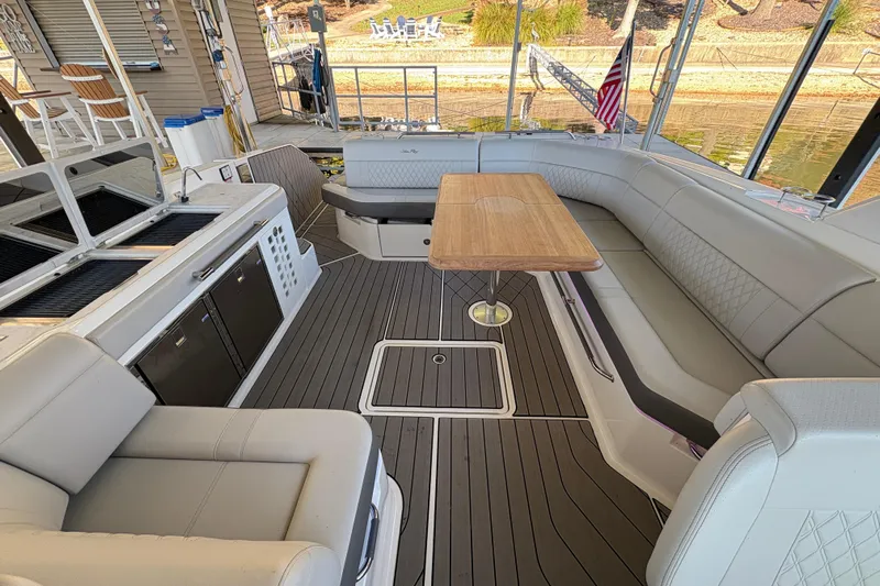  Yacht Photos Pics 2023 Sea Ray SLX 400 boat interior with seating, table, and kitchenette.