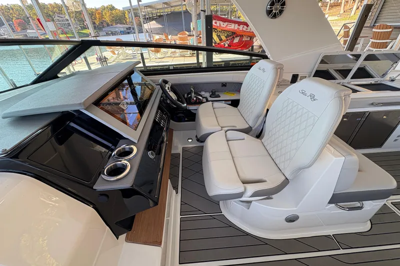  Yacht Photos Pics 2023 Sea Ray SLX 400 boat interior with dual captain's chairs and modern dashboard.