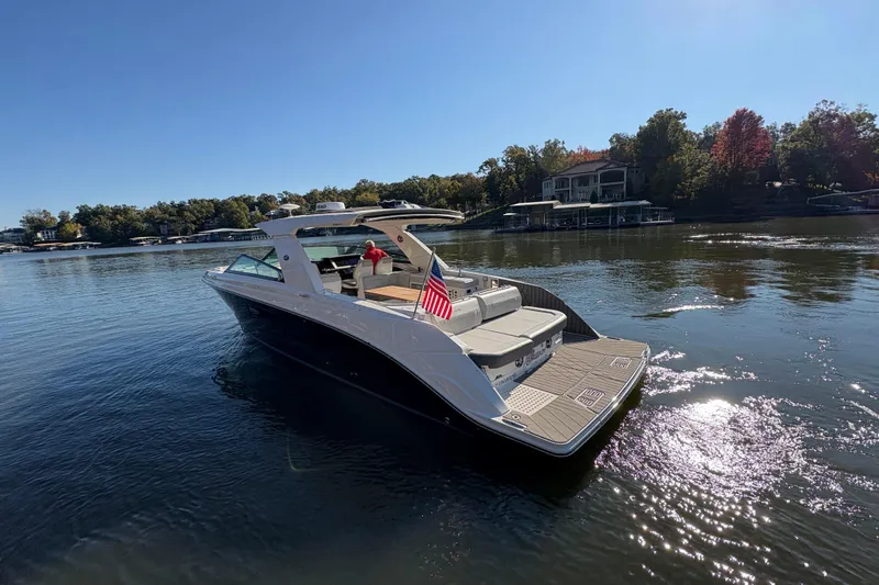  Yacht Photos Pics 2023 Sea Ray SLX 400 boat cruising on a serene lake with scenic background.