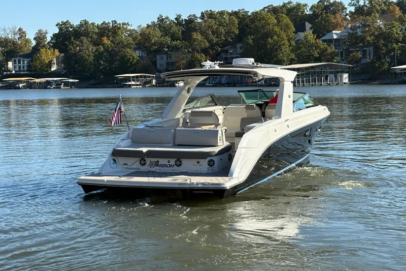  Yacht Photos Pics 2023 Sea Ray SLX 400 luxury boat cruising on a serene lake.