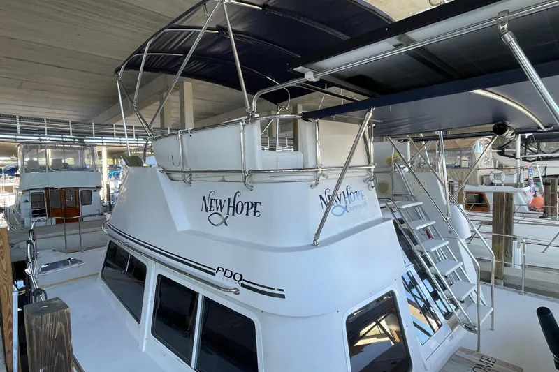 "new Hope" Yacht Photos Pics 2006 PDQ 34 Power Catamaran docked, featuring "New Hope" name and sleek design.