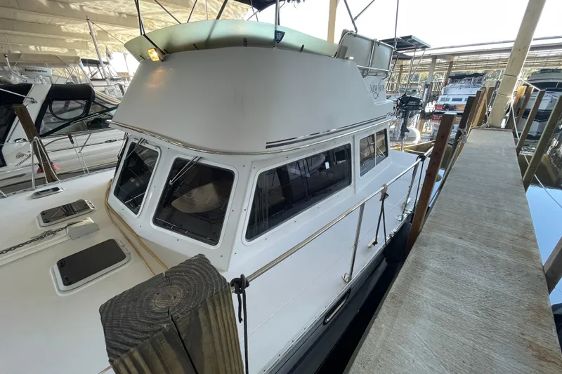 "new Hope" Yacht Photos Pics 2006 PDQ 34 Power Catamaran docked in a marina, showcasing its sleek design.