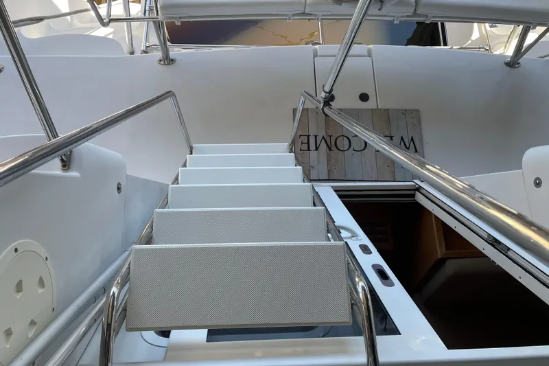 "new Hope" Yacht Photos Pics Staircase on 2006 PDQ 34 Power Catamaran, leading to lower deck with welcome sign.