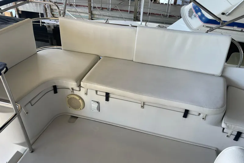 "new Hope" Yacht Photos Pics 2006 PDQ 34 Power Catamaran seating area with white cushions and speaker.