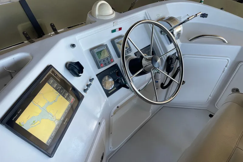 "new Hope" Yacht Photos Pics 2006 PDQ 34 Power Catamaran helm with navigation display and steering wheel.