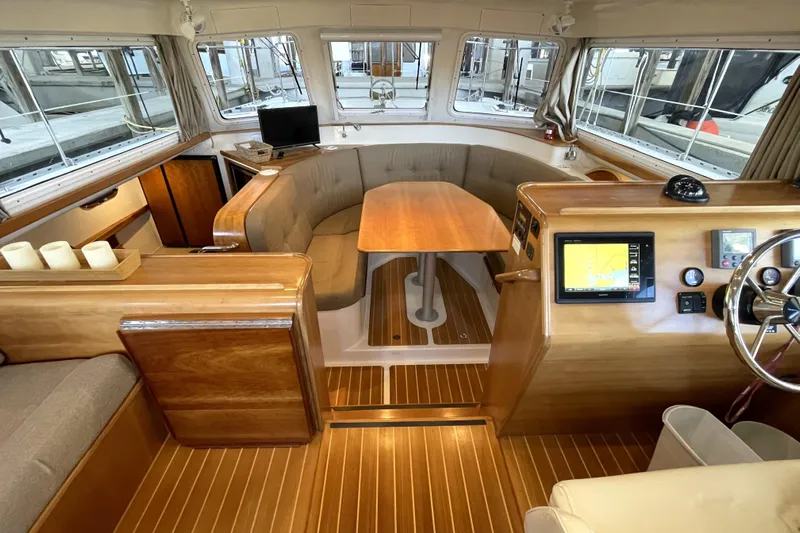"new Hope" Yacht Photos Pics Interior of 2006 PDQ 34 Power Catamaran with wood finishes and navigation equipment.