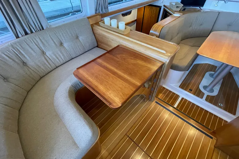 "new Hope" Yacht Photos Pics Interior of 2006 PDQ 34 Power Catamaran with wooden flooring and cozy seating area.