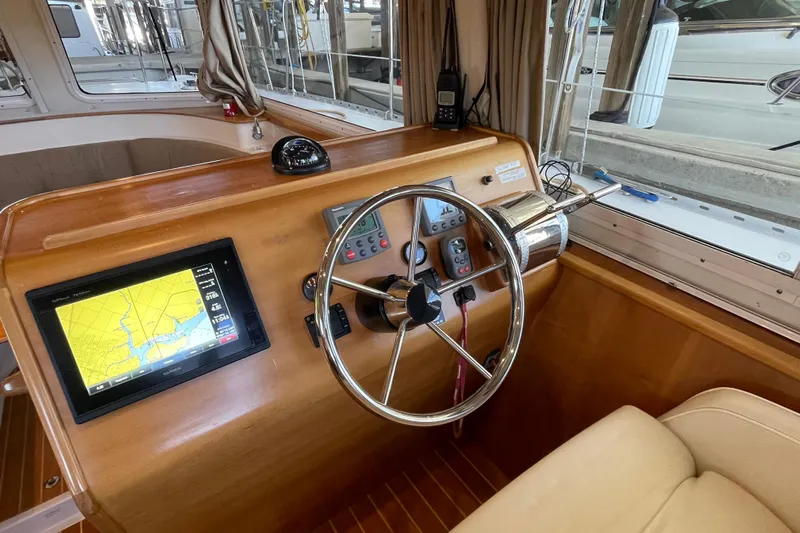 "new Hope" Yacht Photos Pics 2006 PDQ 34 Power Catamaran helm with navigation screen and steering wheel.