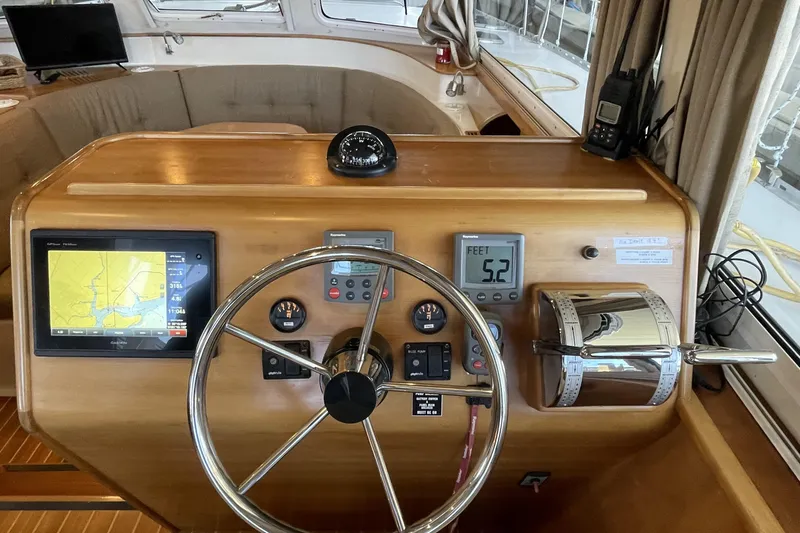 "new Hope" Yacht Photos Pics 2006 PDQ 34 Power Catamaran helm with navigation equipment and steering wheel.