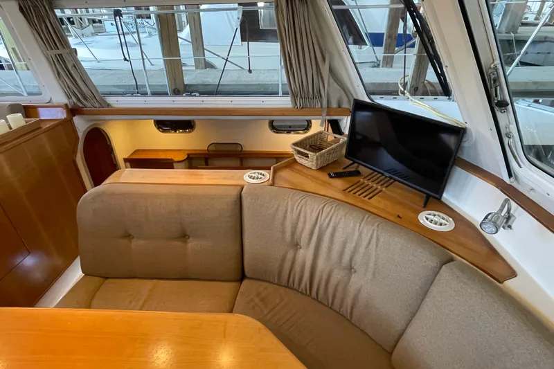 "new Hope" Yacht Photos Pics Interior of 2006 PDQ 34 Power Catamaran with cozy seating and TV.
