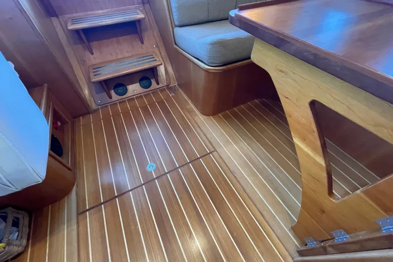 "new Hope" Yacht Photos Pics Interior of 2006 PDQ 34 Power Catamaran with wooden flooring and seating area.