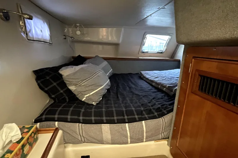 "new Hope" Yacht Photos Pics Cozy cabin interior of 2006 PDQ 34 Power Catamaran with bed and window.