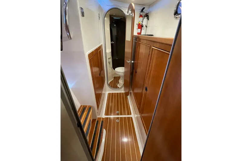 "new Hope" Yacht Photos Pics 2006 PDQ 34 Power Catamaran interior with wood paneling and compact bathroom.