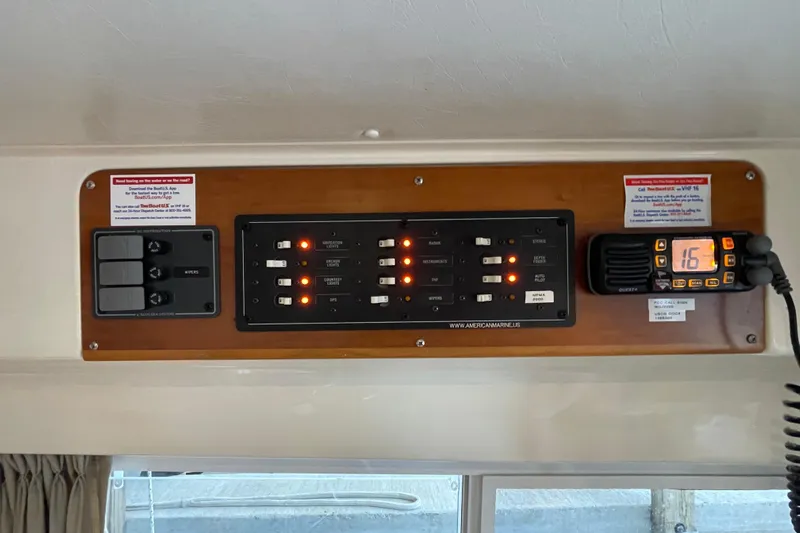 "new Hope" Yacht Photos Pics Control panel of 2006 PDQ 34 Power Catamaran with switches and radio display.