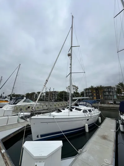 Lanikai Yacht Photos Pics 2007 Hunter 44 Deck Salon sailboat docked at marina under cloudy sky.