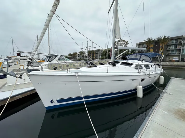 Lanikai Yacht Photos Pics 2007 Hunter 44 Deck Salon sailboat docked at marina, overcast sky.