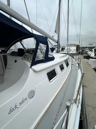 Lanikai Yacht Photos Pics 2007 Hunter 44 Deck Salon sailboat docked at marina, featuring sleek design and spacious deck.