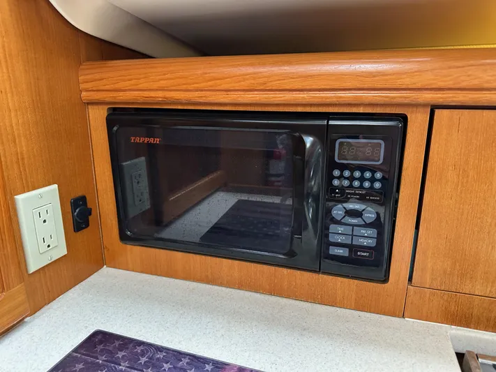 Lanikai Yacht Photos Pics Microwave in 2007 Hunter 44 Deck Salon yacht kitchen with wood cabinetry.