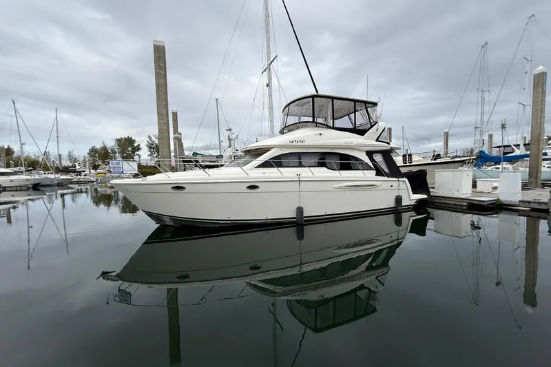  Yacht Photos Pics 2007 Meridian 411 Sedan yacht docked in a marina, reflecting on calm water.