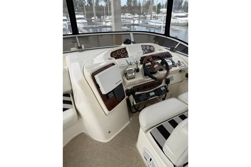  Yacht Photos Pics 2007 Meridian 411 Sedan helm with controls and navigation equipment, docked at marina.