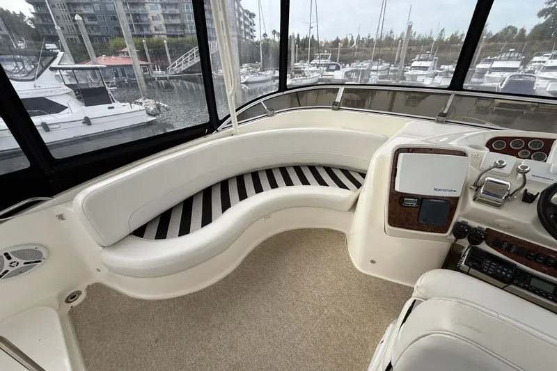  Yacht Photos Pics Luxurious interior of 2007 Meridian 411 Sedan yacht with curved seating and control panel.