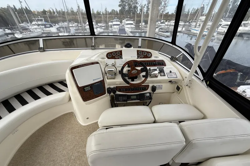  Yacht Photos Pics 2007 Meridian 411 Sedan helm with steering wheel, controls, and marina view.