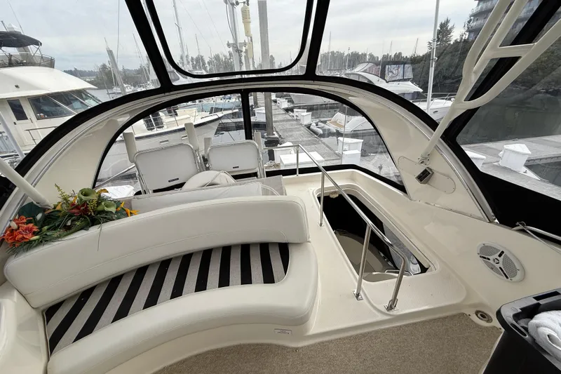  Yacht Photos Pics 2007 Meridian 411 Sedan interior with white seating and marina view.