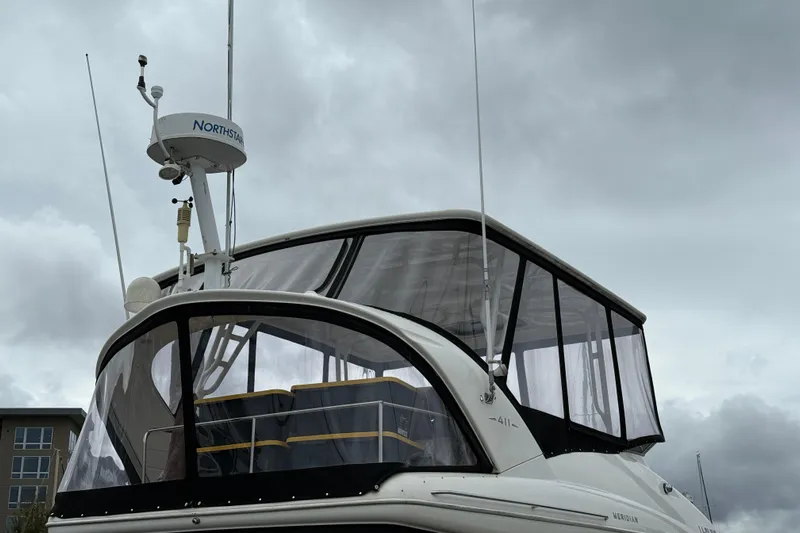  Yacht Photos Pics 2007 Meridian 411 Sedan boat with radar equipment under cloudy skies.