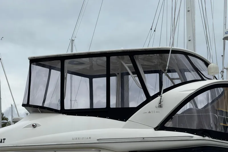  Yacht Photos Pics 2007 Meridian 411 Sedan boat with enclosed flybridge, docked under cloudy skies.