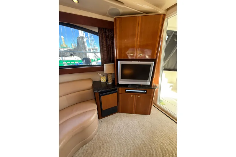  Yacht Photos Pics Interior of 2007 Meridian 411 Sedan yacht with TV, seating, and window view.