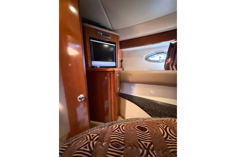  Yacht Photos Pics 2007 Meridian 411 Sedan interior with TV, wood paneling, and patterned bedding.