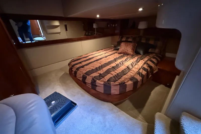  Yacht Photos Pics Luxurious bedroom interior of 2007 Meridian 411 Sedan yacht with striped bedding.