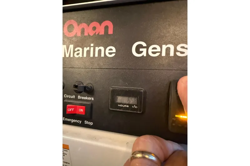  Yacht Photos Pics Onan marine generator control panel with circuit breakers and emergency stop button.