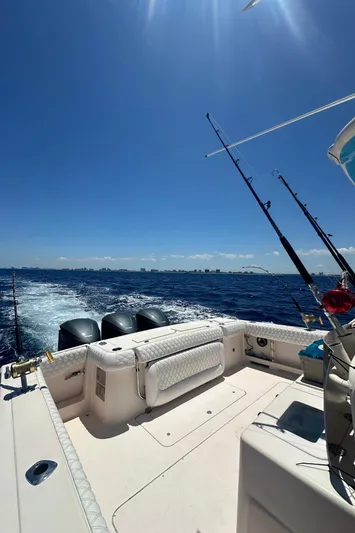 The Office Yacht Photos Pics 2012 Grady-White Canyon 366 boat on open sea with fishing rods.