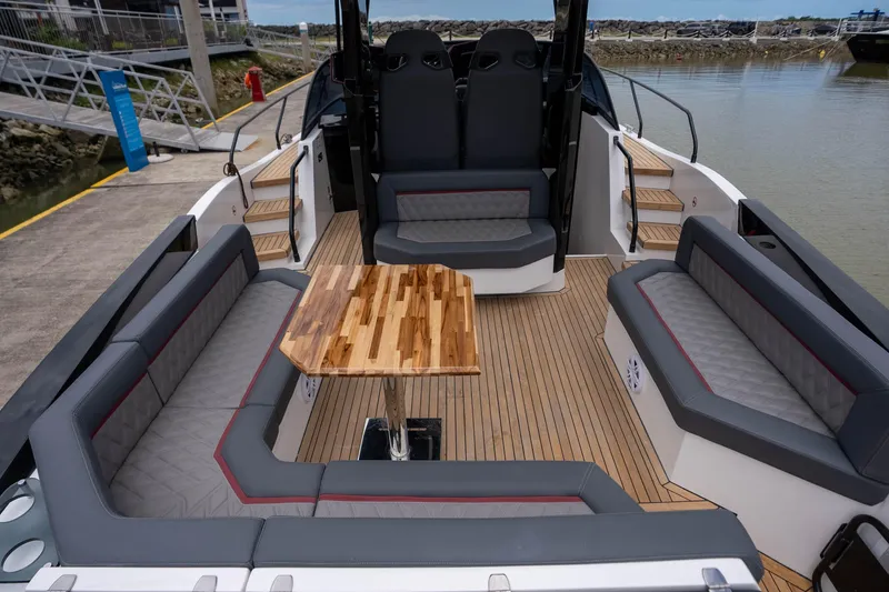  Yacht Photos Pics Luxurious GRAND OCEAN 37 yacht interior, featuring elegant seating and a stylish wooden table, 2026 model.