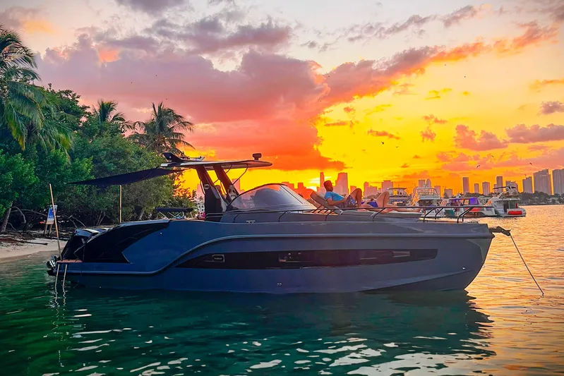  Yacht Photos Pics Luxury GRAND OCEAN 37 yacht at sunset, 2026 model, near tropical shoreline.