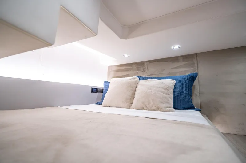  Yacht Photos Pics Luxurious bedroom interior of 2026 GRAND OCEAN 37 yacht with plush pillows.