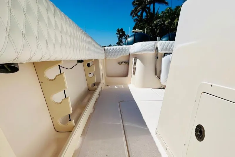 The Office Yacht Photos Pics 2012 Grady-White Canyon 366 boat interior with rod holders and cushioned seating.