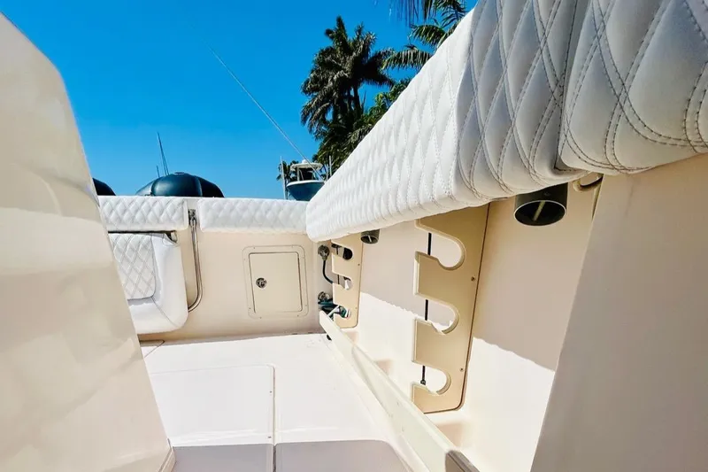 The Office Yacht Photos Pics 2012 Grady-White Canyon 366 boat interior with rod holders and cushioned seating.