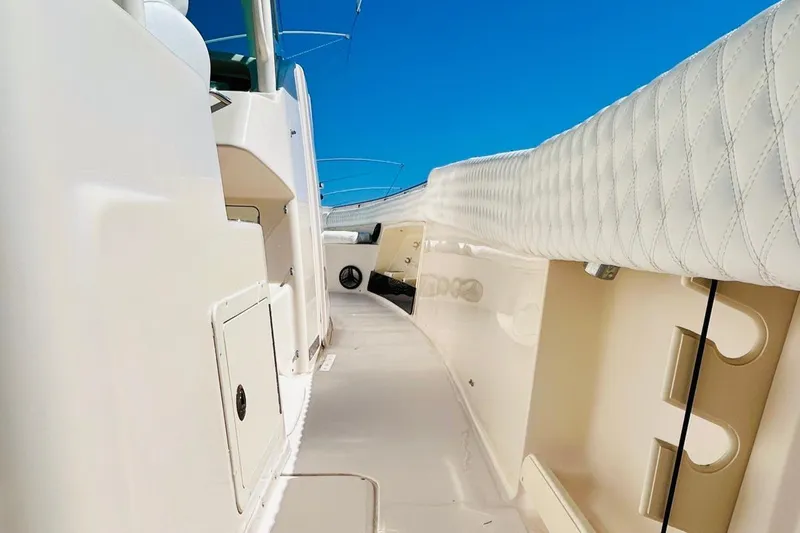 The Office Yacht Photos Pics 2012 Grady-White Canyon 366 boat interior with white upholstery and storage compartments.