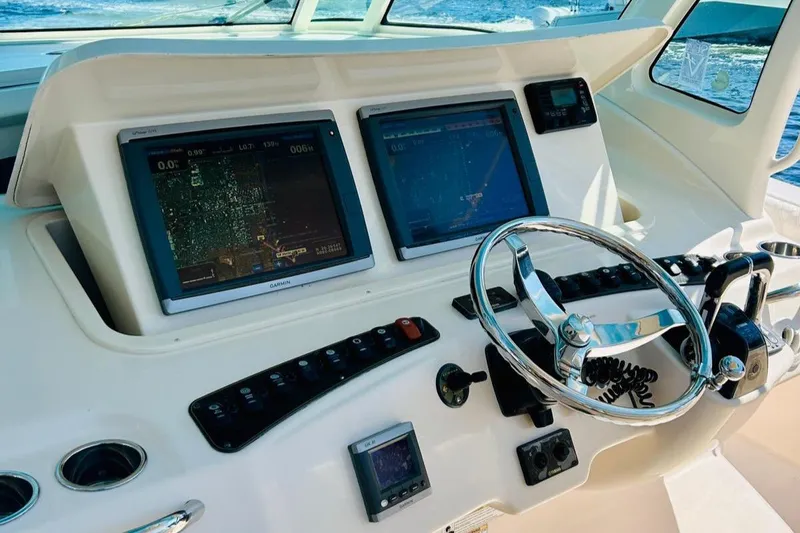 The Office Yacht Photos Pics 2012 Grady-White Canyon 366 helm with dual navigation screens and steering wheel.