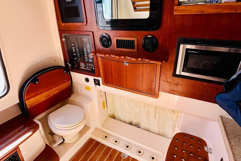 The Office Yacht Photos Pics 2012 Grady-White Canyon 366 boat interior with wood paneling and compact amenities.