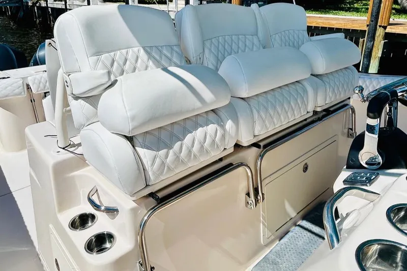 The Office Yacht Photos Pics Luxurious seating on 2012 Grady-White Canyon 366 boat with quilted white upholstery.