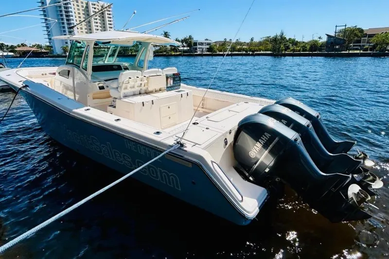 The Office Yacht Photos Pics 2012 Grady-White Canyon 366 boat with triple Yamaha engines docked on water.