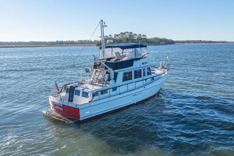 Cheers Yacht Photos Pics 1989 Grand Banks 46 Classic yacht cruising on a serene waterway.