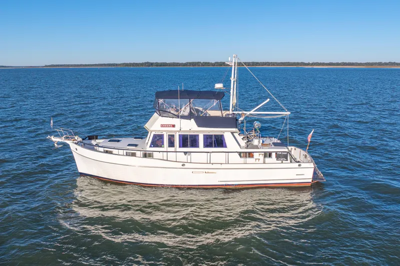 Cheers Yacht Photos Pics 1989 Grand Banks 46 Classic yacht on open water under clear blue sky.