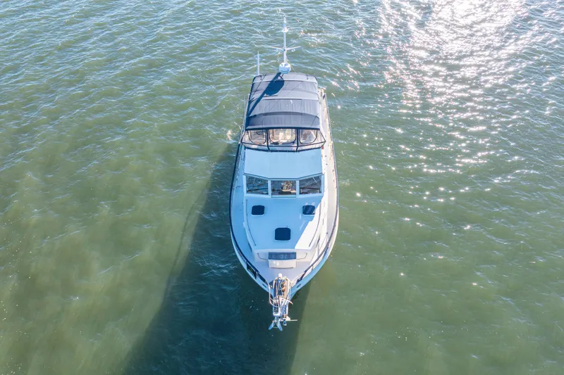 Cheers Yacht Photos Pics Aerial view of 1989 Grand Banks 46 Classic yacht on shimmering water.
