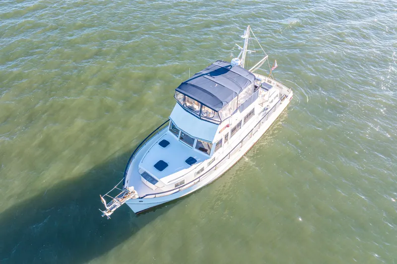 Cheers Yacht Photos Pics Aerial view of 1989 Grand Banks 46 Classic yacht cruising on open water.