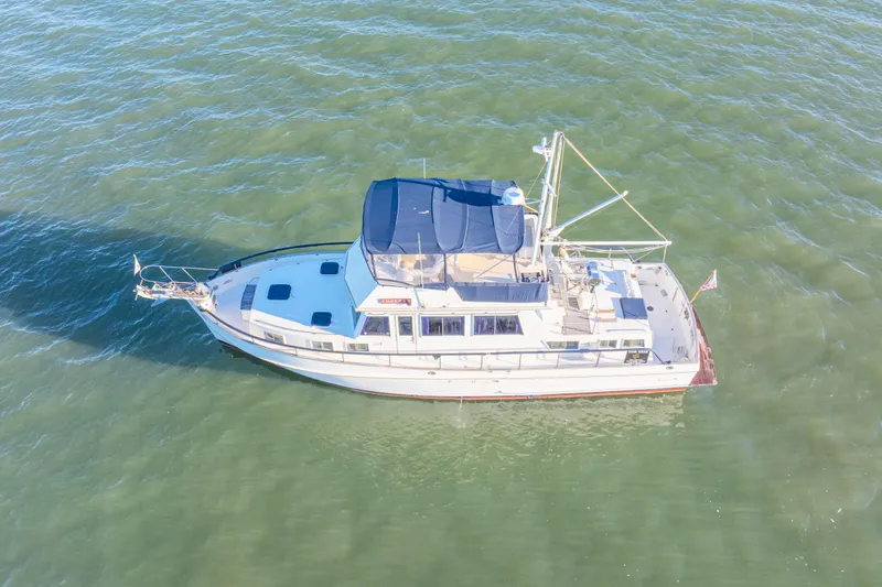 Cheers Yacht Photos Pics 1989 Grand Banks 46 Classic yacht cruising on open water, aerial view.